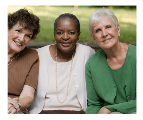 Three smiling senior women outdoors on a sunny day